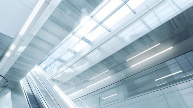 a sleek, modern office environment showcases a series of advanced permanent fall protection systems installed on the ceilings and walls, emphasizing safety and innovation in transportation and public buildings.